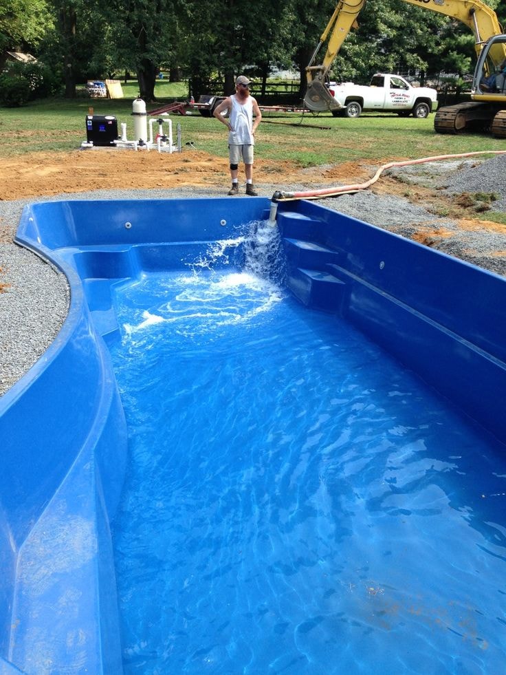 Blue fiberglass pool being filled with bulk water delivery in Mullica Hill NJ